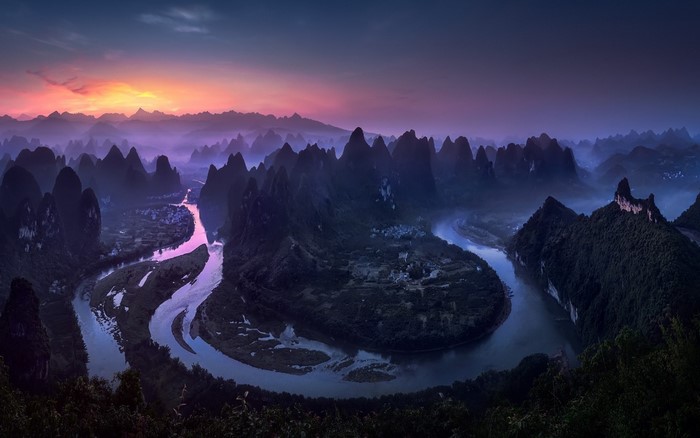 Karst landscape with river at sunset