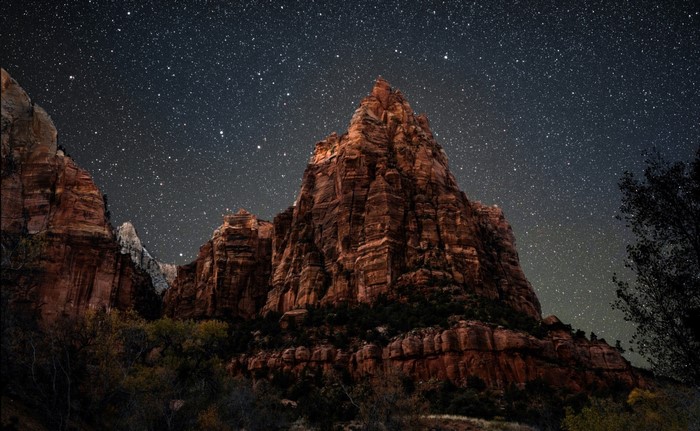 Mountain peak under a starry night sky