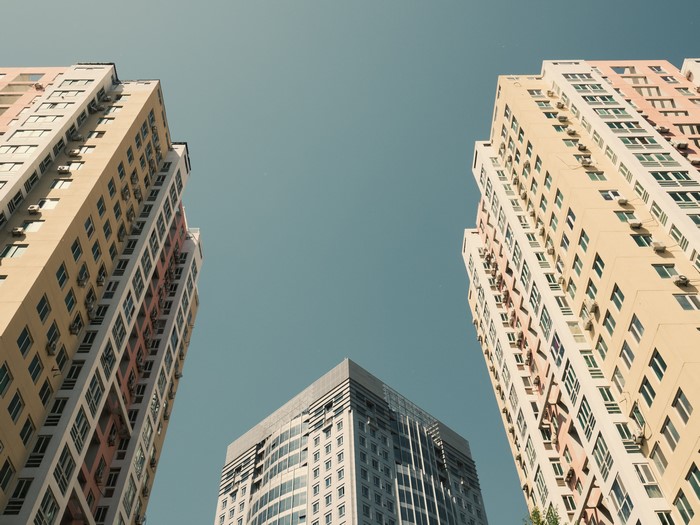 Three tall buildings against a clear sky