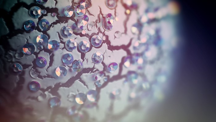 Close-up of iridescent rhinestones on cracked surface