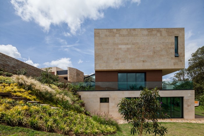 Modern stone mansion with landscaped hillside