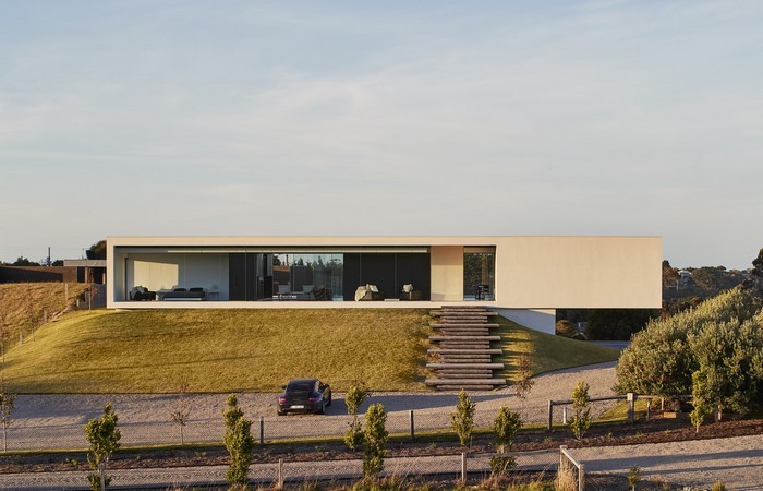 Modern house with Porsche 911 on driveway