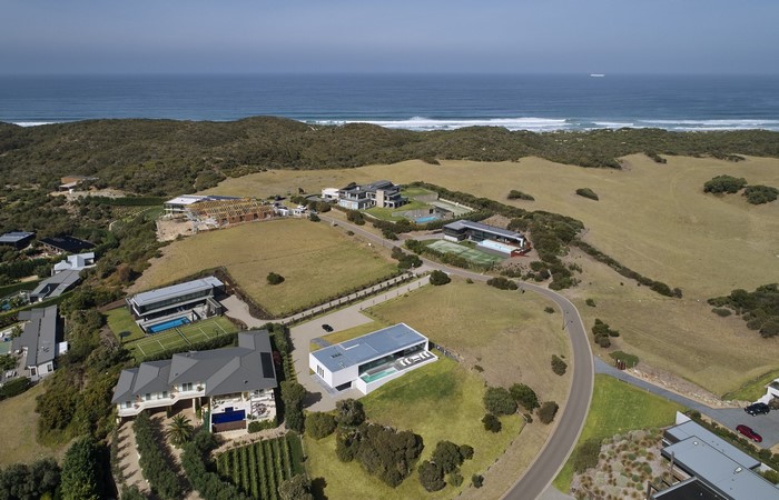 Modern mansions on a coastal hillside with ocean views