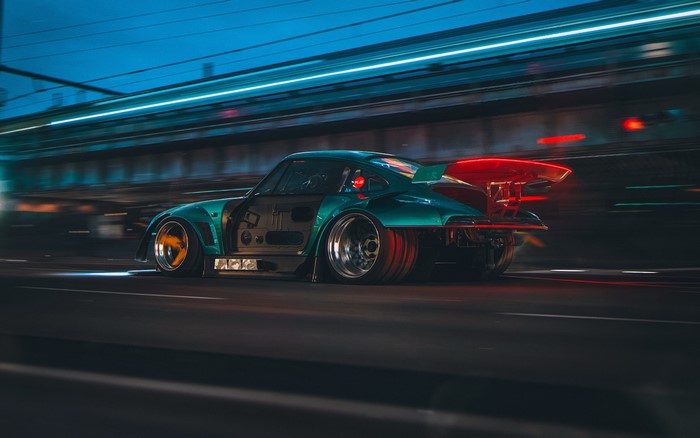 Futuristic custom Porsche 911 concept car driving at night