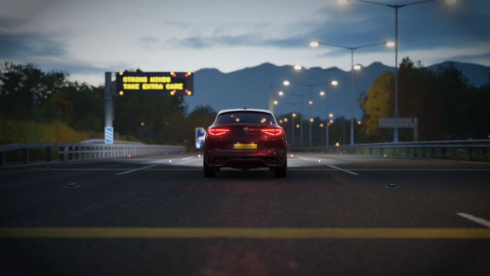 Alfa Romeo Stelvio on a highway at dusk