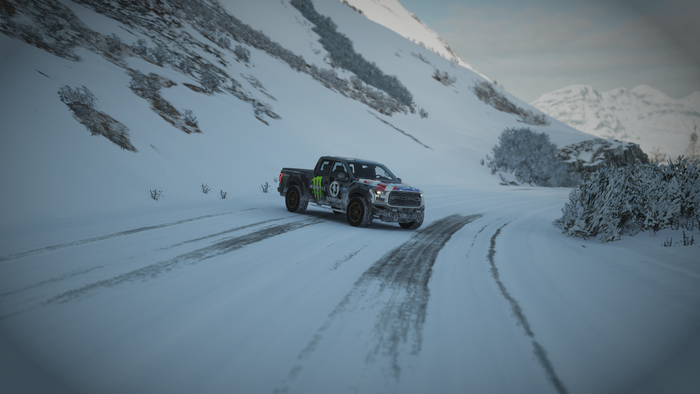 Ford Raptor driving on a snowy mountain road
