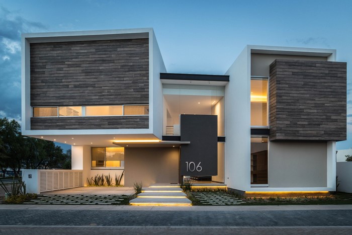 Modern house with wood accents and outdoor lighting