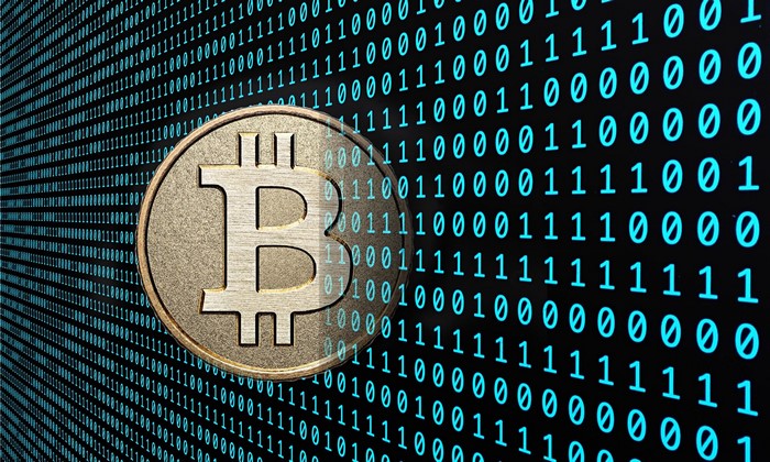 Bitcoin coin on a background of binary code