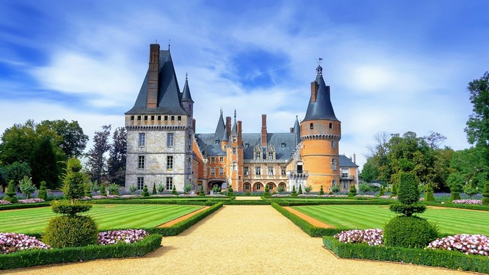Chateau de Pierrefonds castle in France with manicured gardens