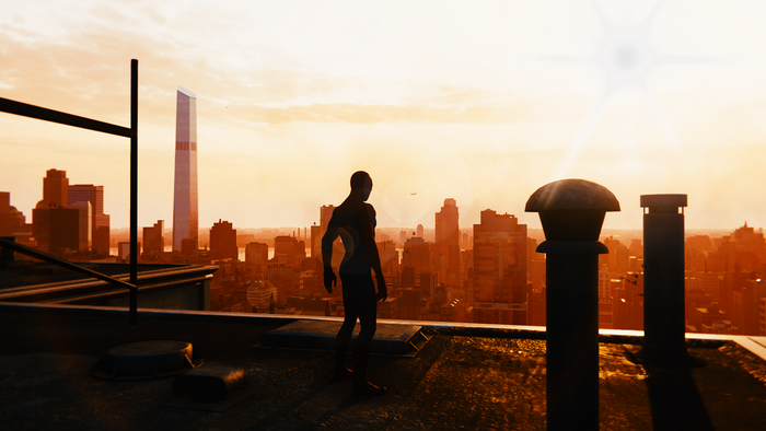 Spider-Man on a rooftop overlooking a city at sunset
