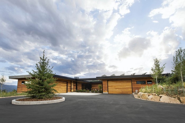 Modern luxury house with wooden facade and solar panels