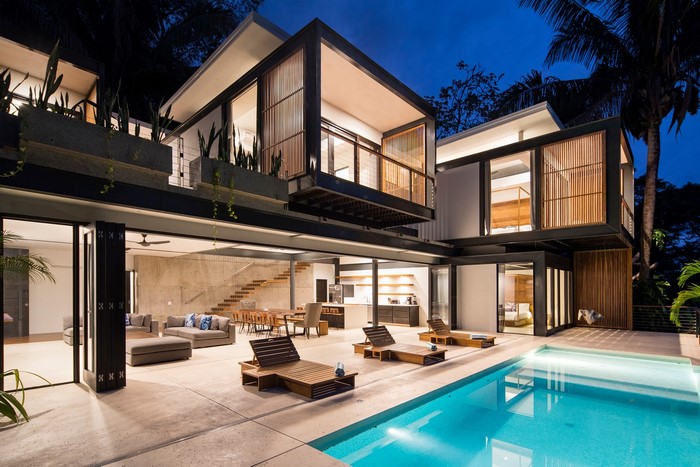 Modern luxury mansion with swimming pool at dusk