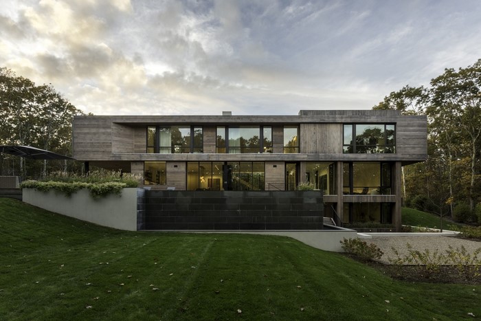 Modern luxury house with large windows and wooden exterior