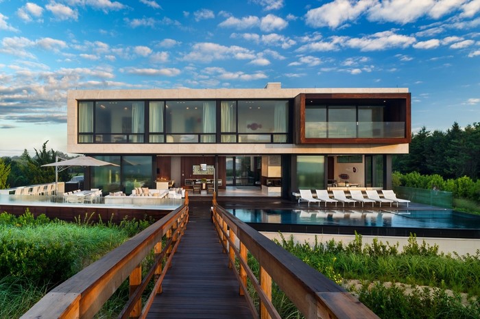 Modern luxury house with swimming pool and wooden bridge