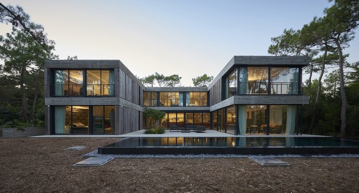 Modern concrete house with swimming pool and trees