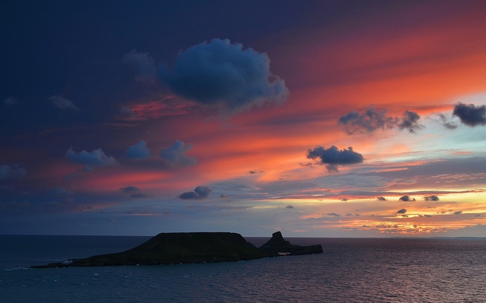 Island in the sea during sunset