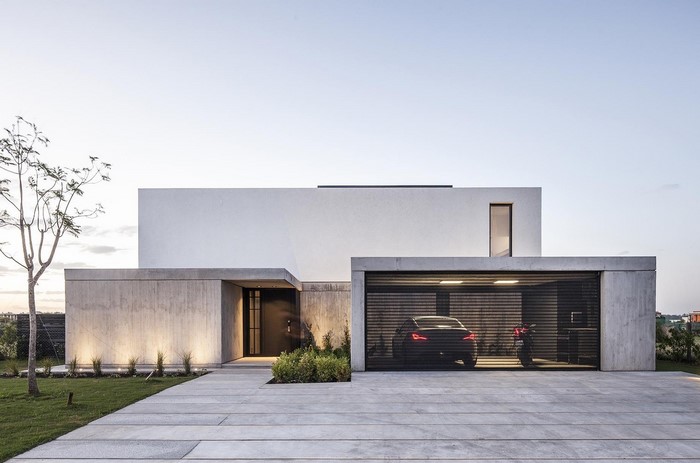 Modern concrete house with garage and car
