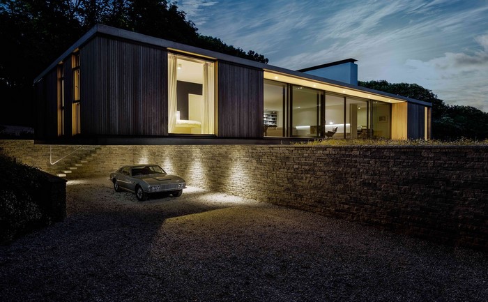 Modern house with a vintage car at night