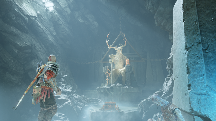 Kratos from God of War in a cave with a statue