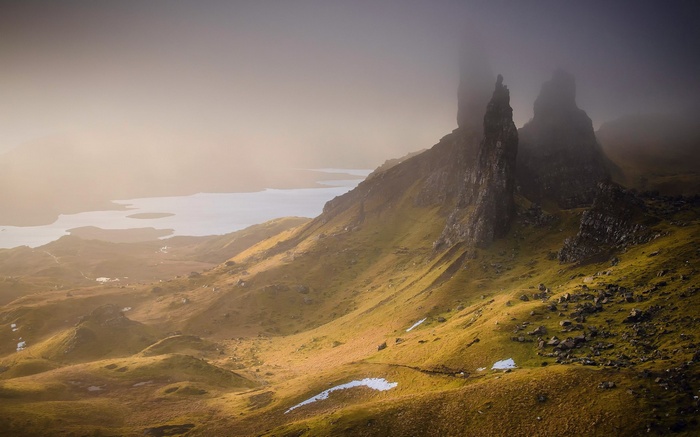 Misty mountains and a lake at sunrise