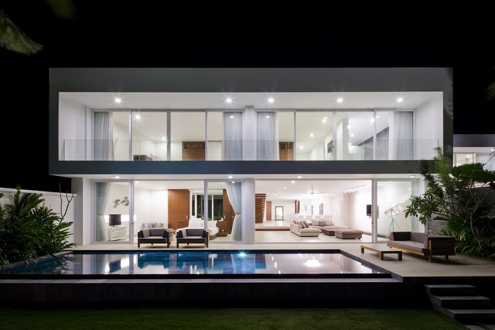 Modern luxury house with swimming pool at night