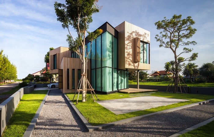 Modern wooden and glass house with trees