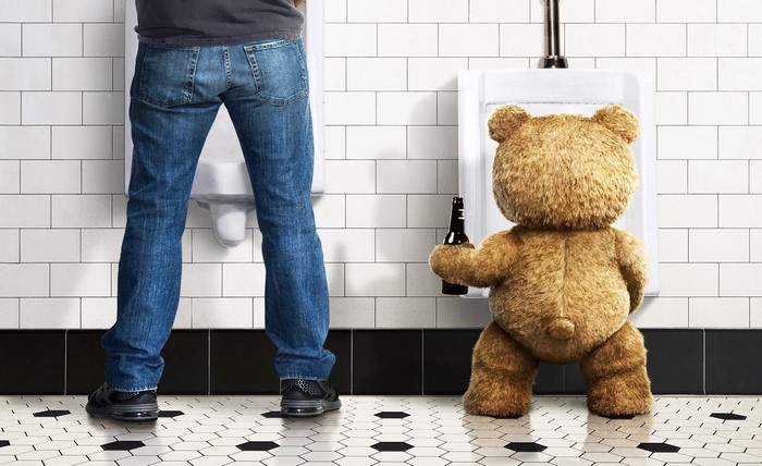 Ted from Ted holding a beer in a bathroom