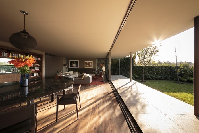 Modern house interior with large windows and garden view