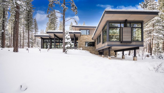 Modern house in a snowy forest