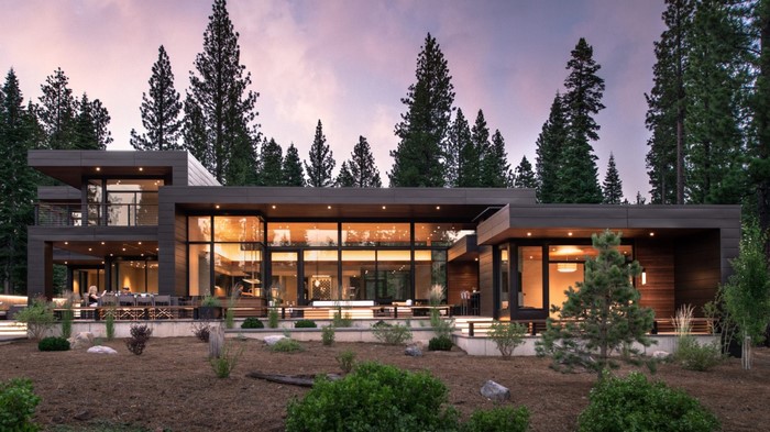 Modern house with large windows in a forest
