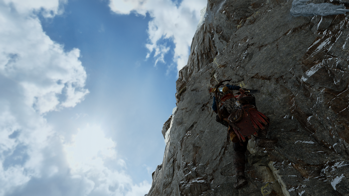 Kratos climbing a rocky mountain in God of War