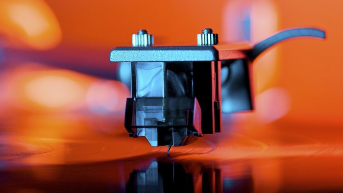 Close-up of a turntable cartridge on a vinyl record