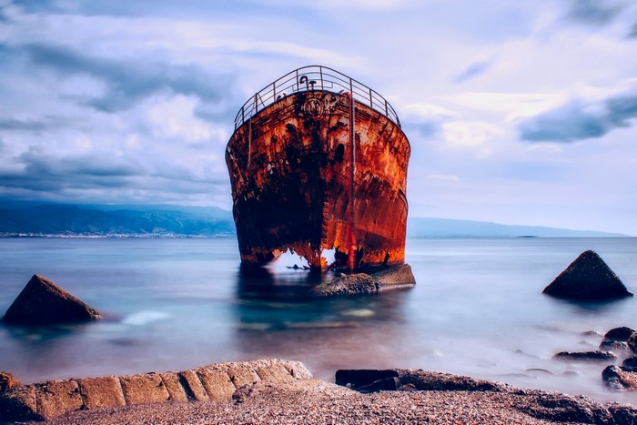 Rusty shipwreck stranded in the sea