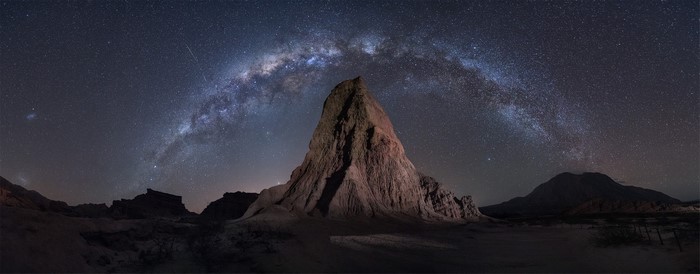 Milky Way over a rocky desert landscape at night