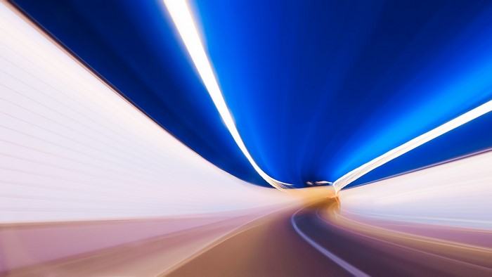 Blurred tunnel with blue ceiling and lights