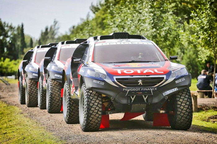 Peugeot Rally Cars Lined Up on Dirt Track