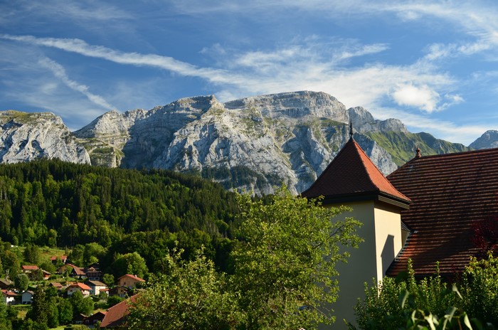 Mountain village with church tower and mountains