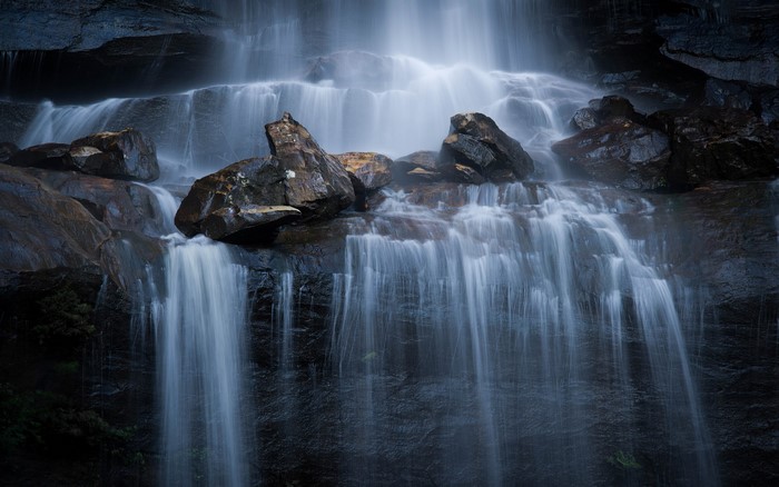 Waterfall cascading over wet rocks