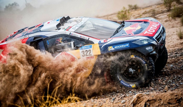 Peugeot 3008 DKR rally car racing through dirt