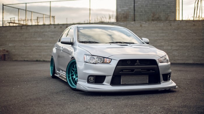 Silver Mitsubishi Lancer EVO with Teal Wheels