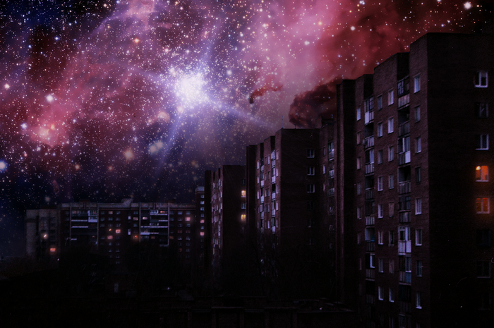 Apartment buildings under a starry galaxy sky