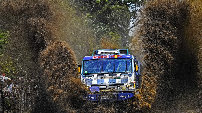 Kamaz truck racing through mud and water