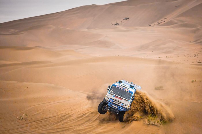 Kamaz truck racing through desert sand dunes