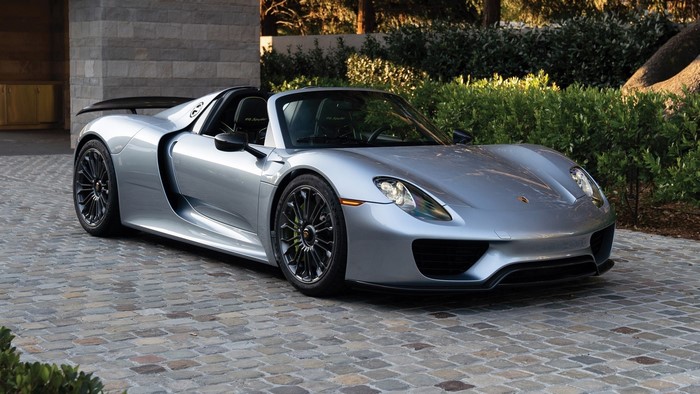Silver Porsche 918 Spyder sports car on cobblestone