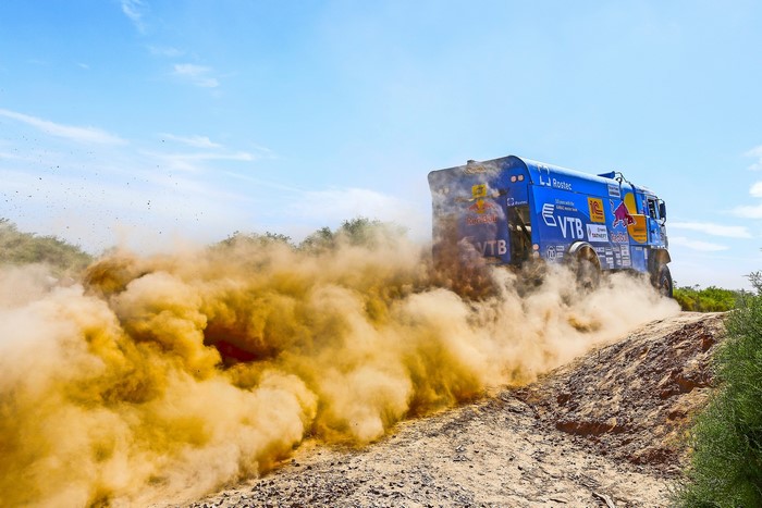 Kamaz truck racing through dust