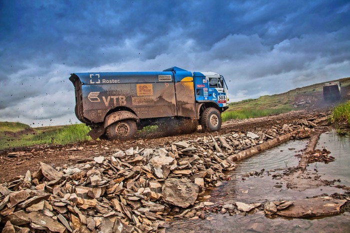 Kamaz truck racing in Dakar Rally on a muddy track