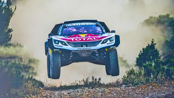 Peugeot Rally Car Jumping in Dusty Terrain