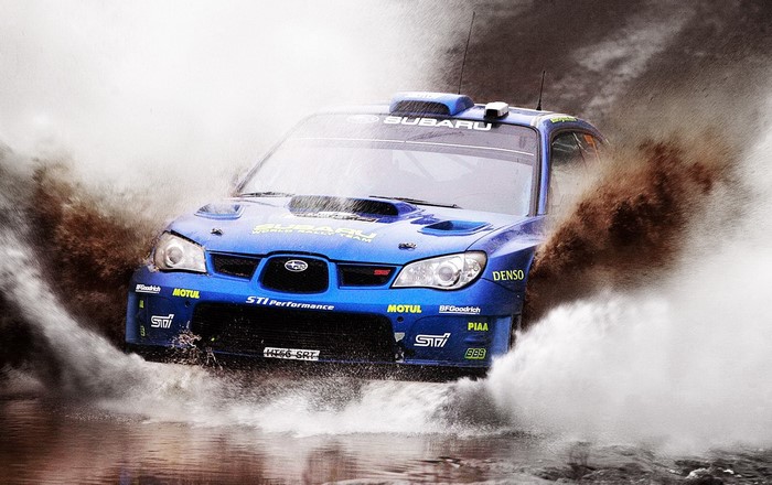 Blue Subaru Impreza WRX STi rally car driving through water