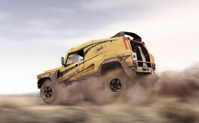 Yellow Bowler racing vehicle kicking up dust