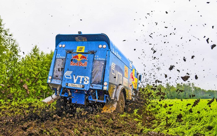 Kamaz truck racing through mud with Red Bull and VTB logos